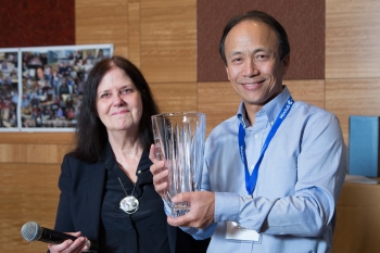 Nell Sedransk gives Jiming Jiang the Former Postdoc Achievement Award at the JSM reception. Nell Sedransk and Jiming Jiang