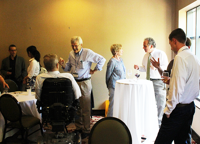 Forum participants continue conversation at reception