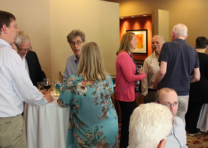 Forum participants continue conversation at reception